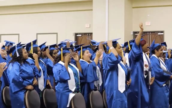Centura College students at graduation clapping and excited